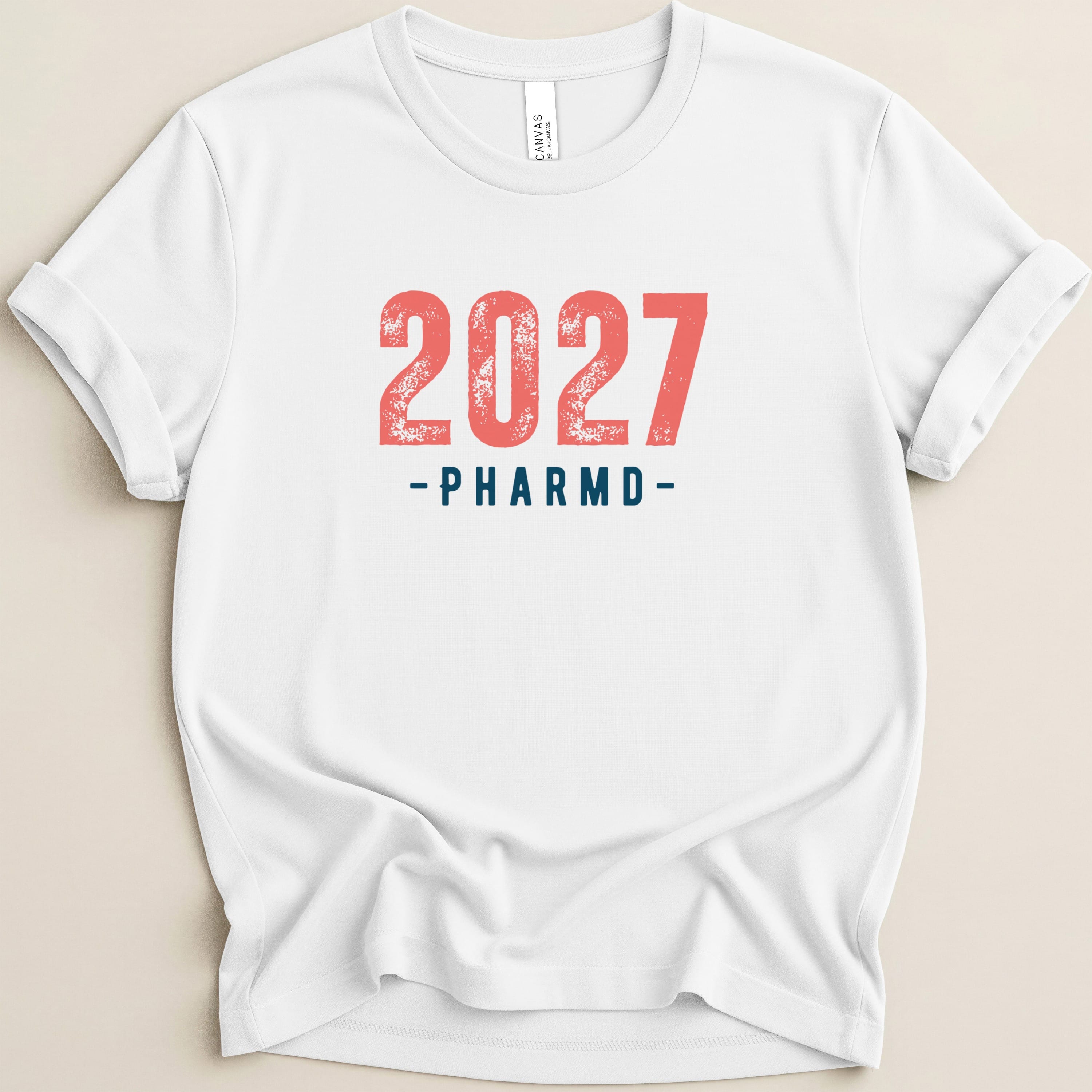 White t-shirt with "2027 PHARMD" in red and blue text.