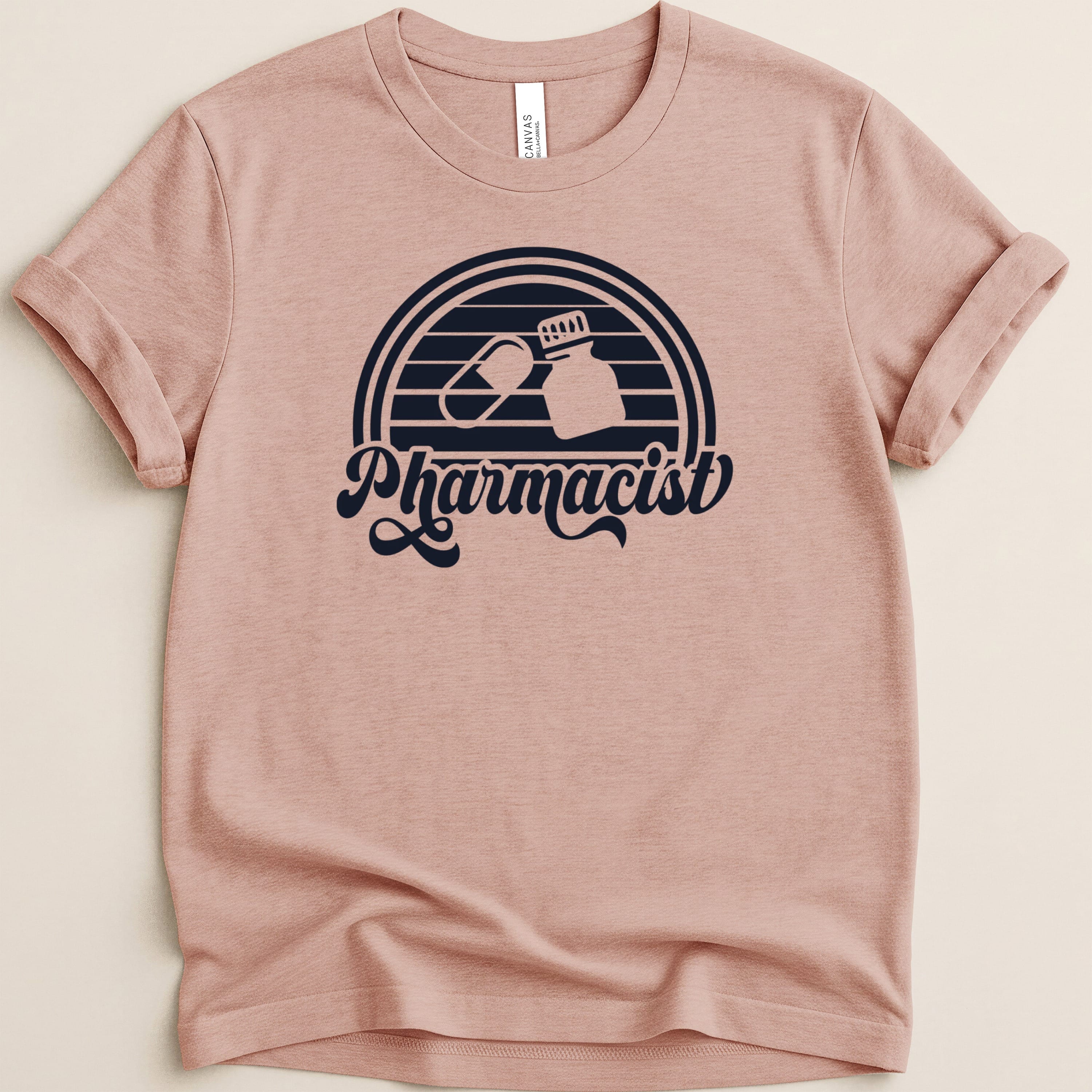 Pink t-shirt with retro "Pharmacist" text and pill graphic.