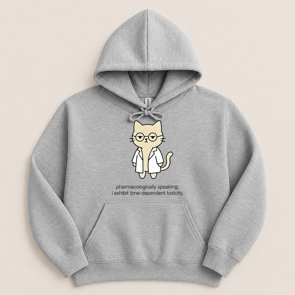 Grey hoodie with cartoon cat in a lab coat and glasses, text says "pharmacologically speaking, I exhibit time-dependent toxicity."