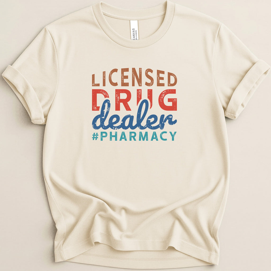 Cream t-shirt with "Licensed Drug Dealer #Pharmacy" graphic.