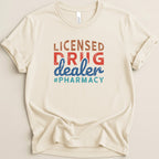 Cream t-shirt with "Licensed Drug Dealer #Pharmacy" graphic.