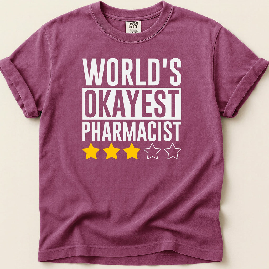 Maroon t-shirt with "WORLD'S OKAYEST PHARMACIST" and three yellow stars.