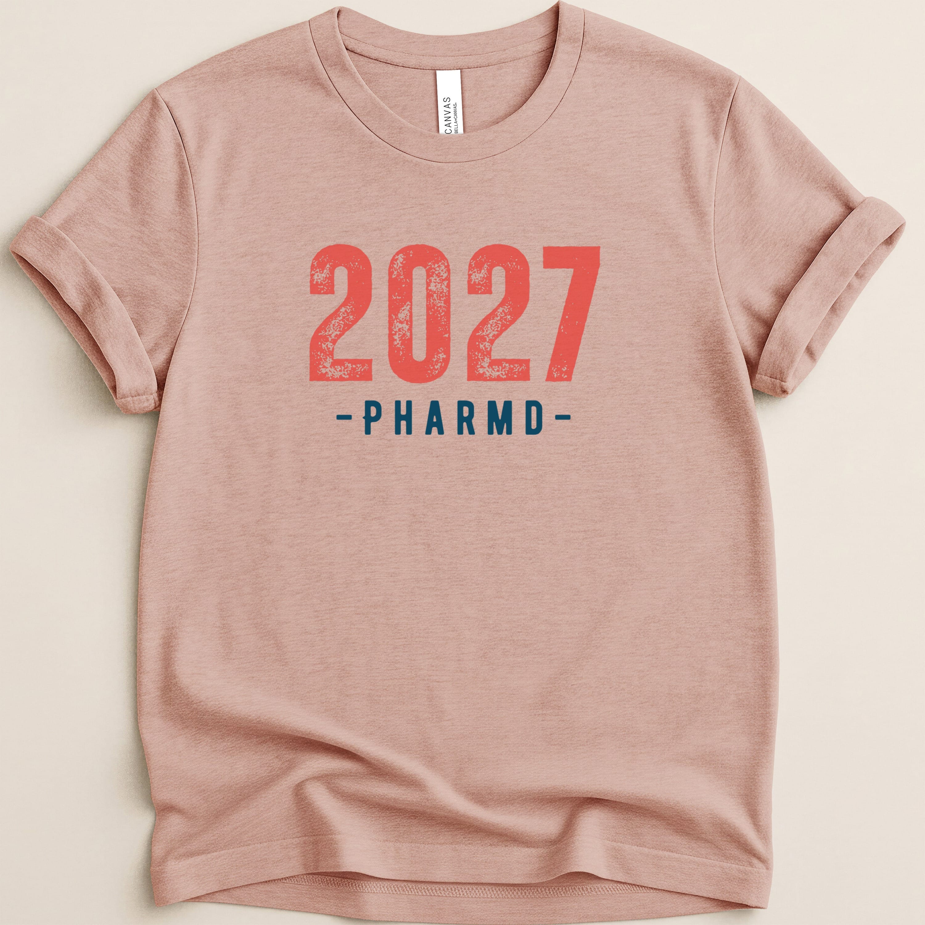 Pink t-shirt with "2027 PHARMD" text in red.