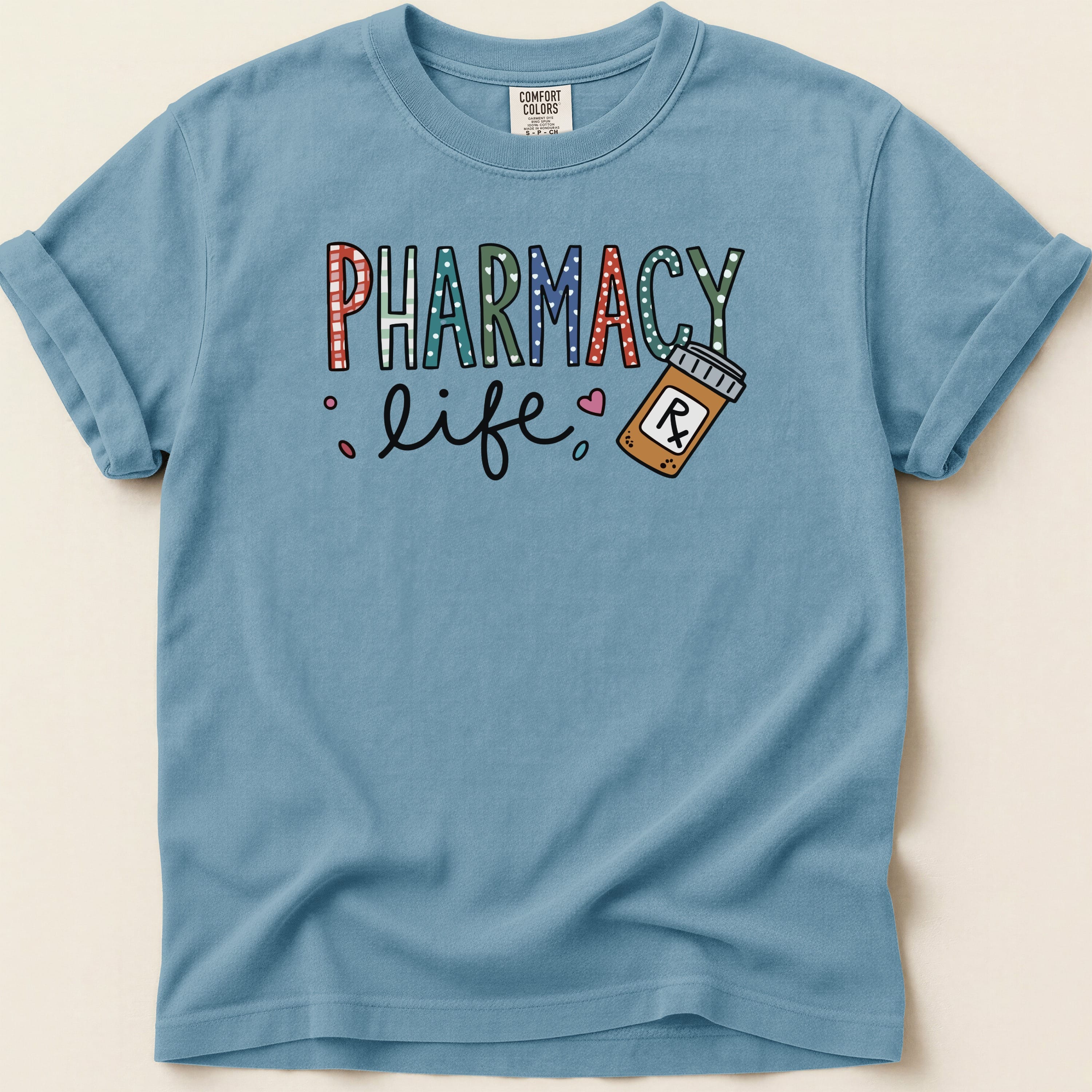 Blue t-shirt with "PHARMACY life" text and a pill bottle.