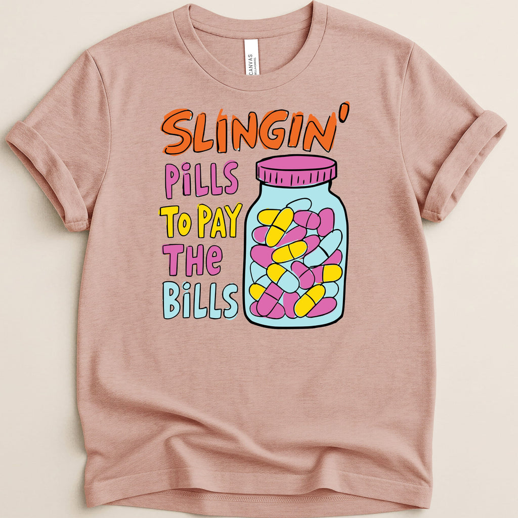 T-shirt with text "Slingin' Pills To Pay The Bills" and a jar of pills.