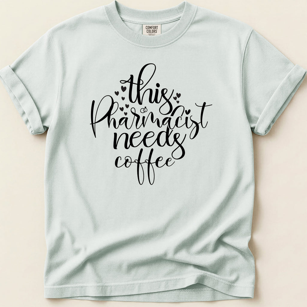 Comfort Colors t-shirt with "this pharmacist needs coffee" text and small hearts.