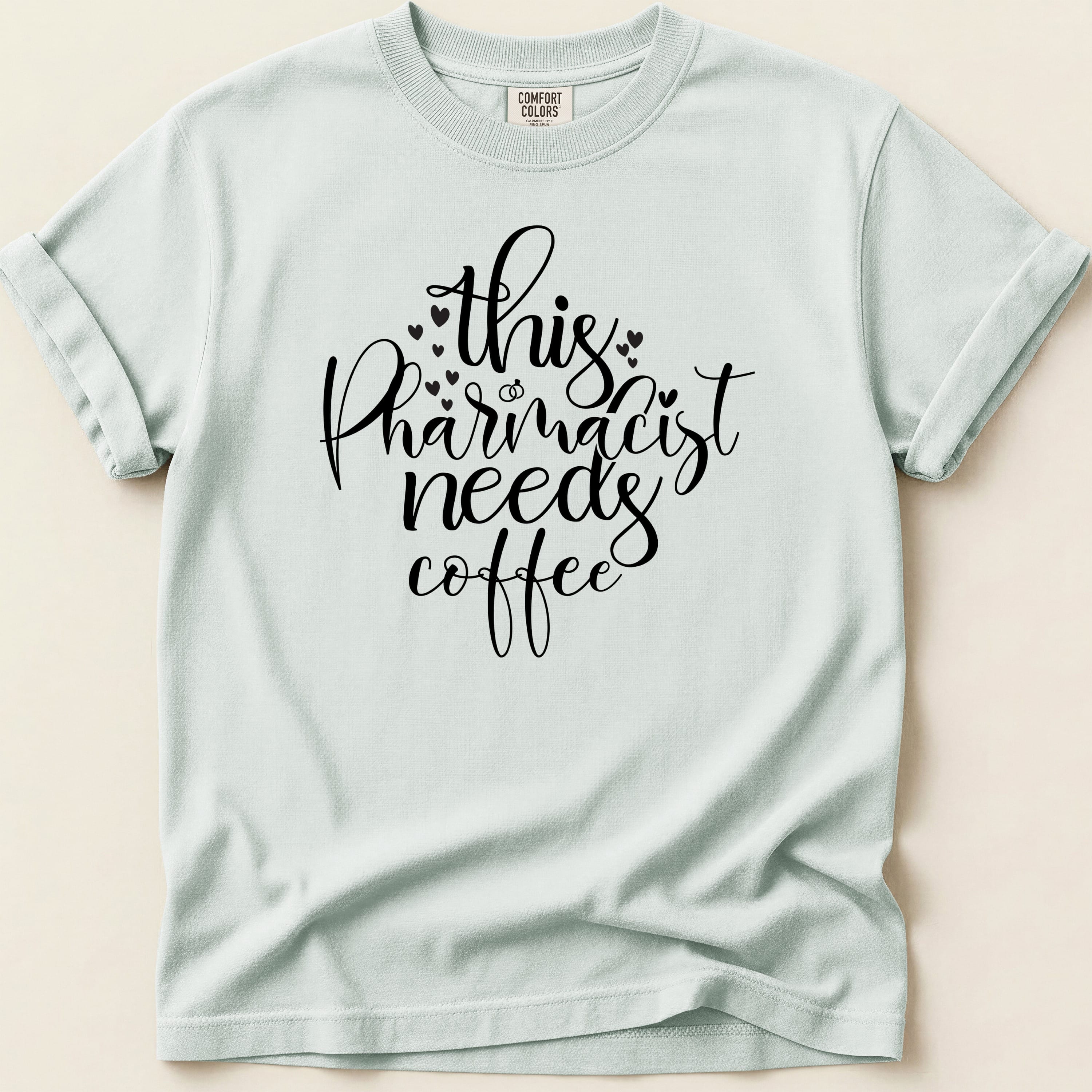 Comfort Colors t-shirt with "this pharmacist needs coffee" text and small hearts.