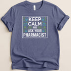 Blue t-shirt with "KEEP CALM AND ASK YOUR PHARMACIST" text and geometric pattern.