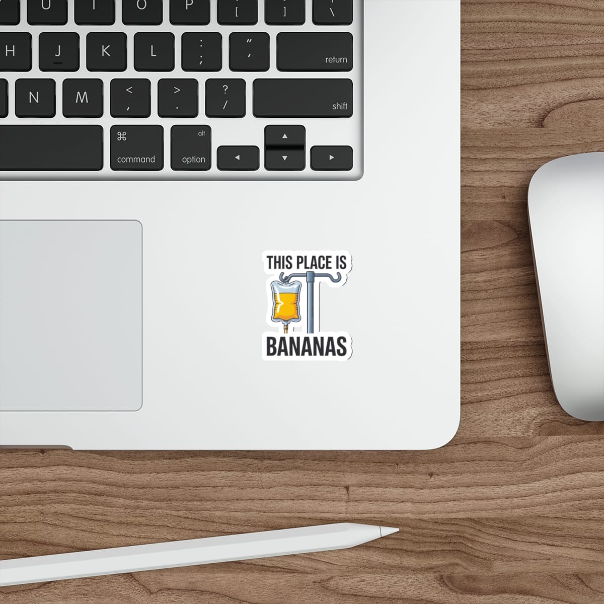 Sticker on a laptop displaying "THIS PLACE IS BANANAS" with an IV bag.