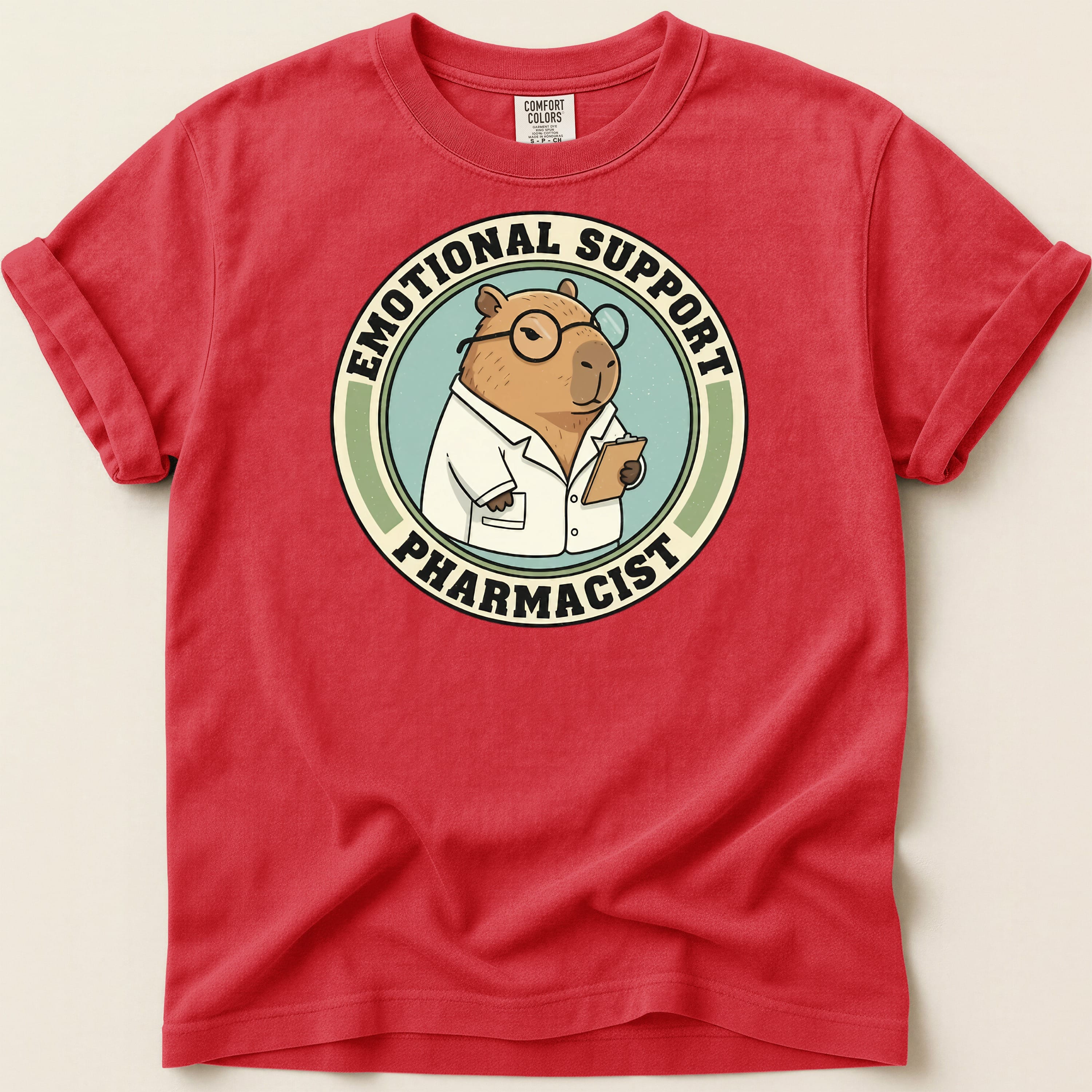 Red t-shirt with "Emotional Support Pharmacist" capybara graphic.
