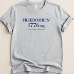 Grey t-shirt with "FREEDOMICIN 1776 mg As Needed for Patriotism" text.