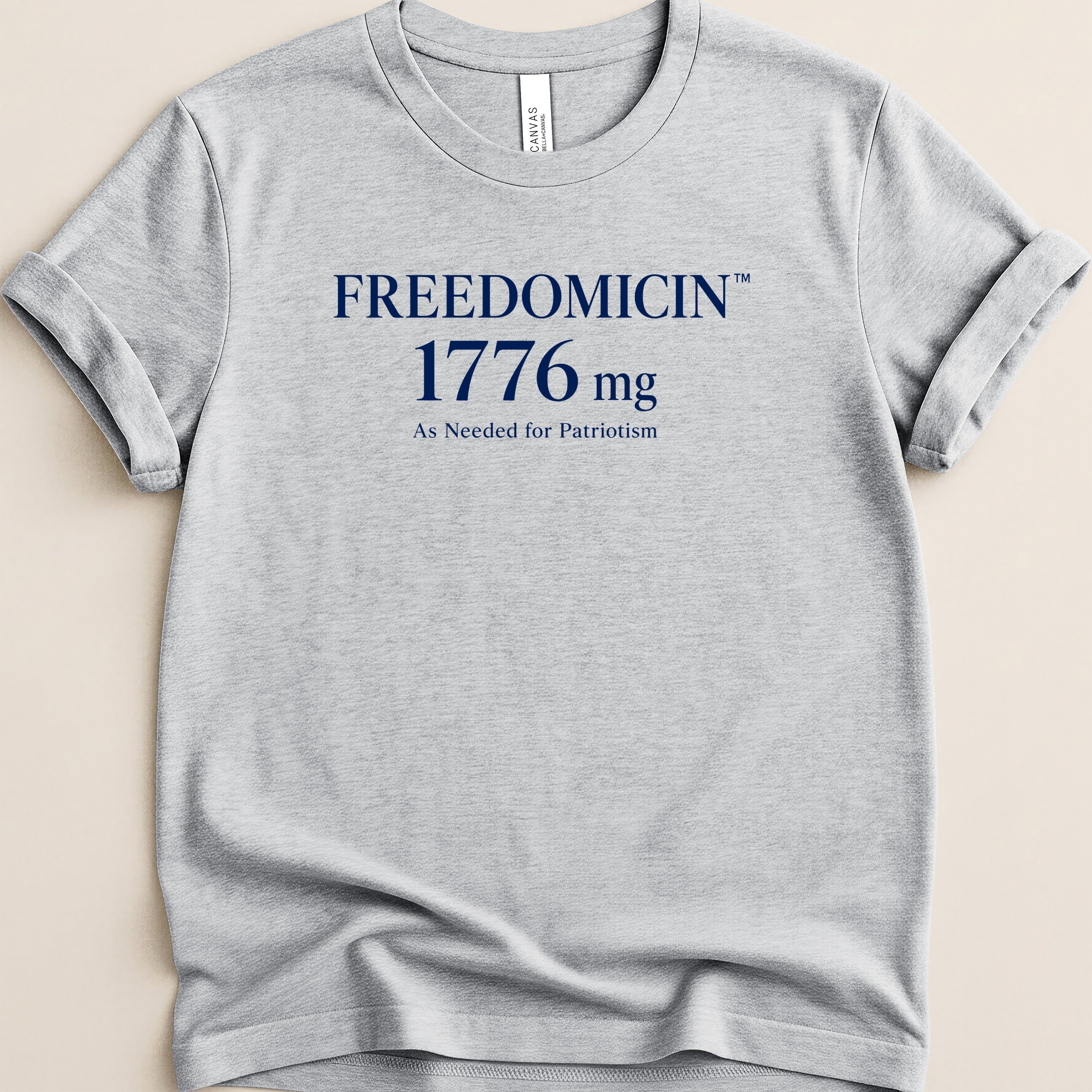 Grey t-shirt with "FREEDOMICIN 1776 mg As Needed for Patriotism" text.