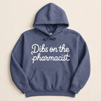 Blue hooded sweatshirt with "Dibs on the pharmacist" text.