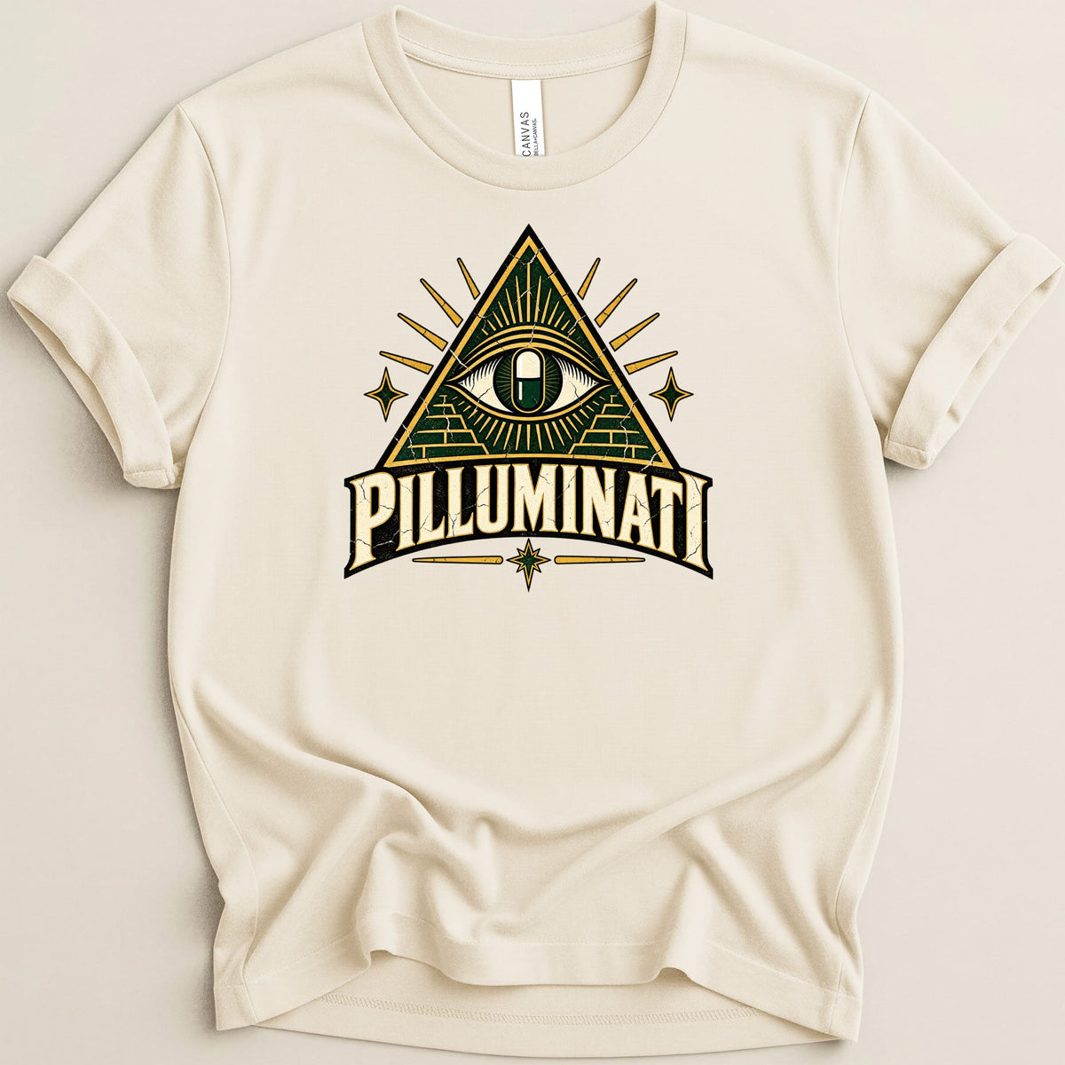 Cream t-shirt with a distressed graphic featuring a pyramid, an eye containing a pill, and the text "PILLUMINATI".