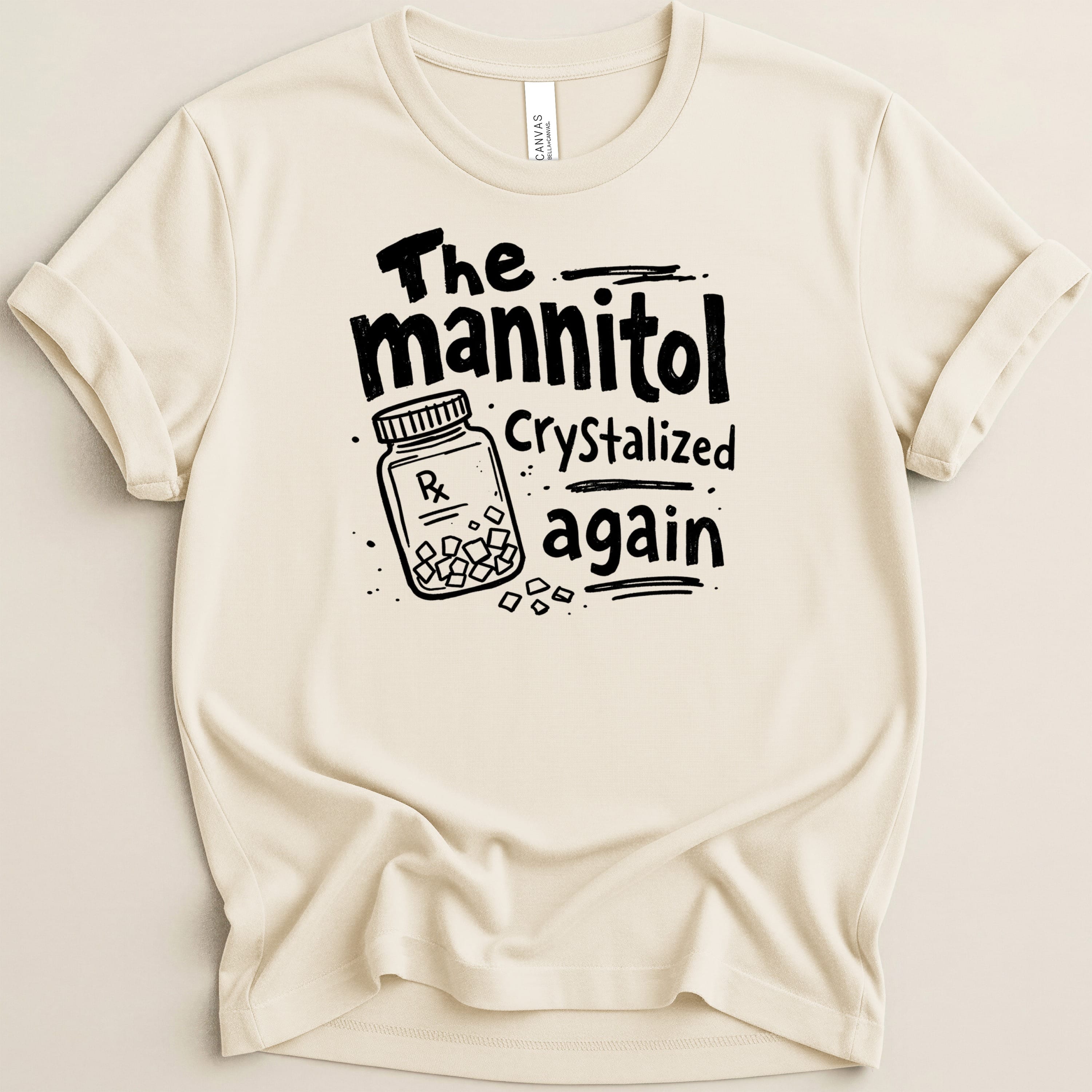 Cream t-shirt with black graphic of a prescription bottle and text "The mannitol crystallized again".